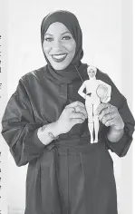  ?? COURTESY OF MATTEL ?? U.S. Olympic fencer Ibtihaj Muhammad holds the Barbie doll fashioned in her likeness Monday.