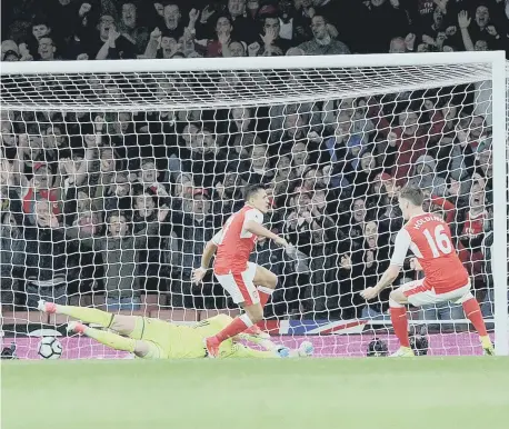  ??  ?? Arsenal’s Alexis Sanchez opens the scoring past Sunderland’s Jordan Pickford. Picture by Frank Reid.