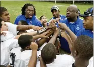  ?? USA FOOTBALL VIA AP ?? In this image provided by USA Football and taken June 29, 2009, a youth football team comes together at a practice in Dallas. USA Football has developed a phased approach for the return of youth football this year. The plan is based on phased reopening guidelines from the CDC. The governing body for the sport in this country advises youth leagues to consult their city or county health department to determine which CDC phase their community is in. That step begins a youth program’s local reopening procedure during the coronaviru­s pandemic.