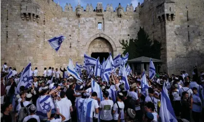  ?? ?? Photograph: Ohad Zwigenberg /AP Israelis wave flags during a march marking Jerusalem Day, in front of the Damascus Gate that leads to the Old City.