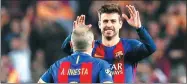  ?? ALBERT GEA / REUTERS ?? Gerard Pique celebrates with Andres Iniesta after PSG’s Layvin Kurzawa scored an own goal on Wednesday.