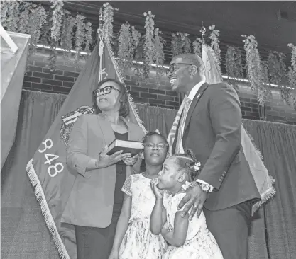  ?? JOVANNY HERNANDEZ/MILWAUKEE JOURNAL SENTINEL ?? Milwaukee County Executive David Crowley is joined by his family as he prepares to take an oath for his inaugurati­on on Thursday at Venue 3 in the Third Street Market Hall.