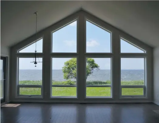  ?? Sunset Acres ?? The lake is visible through large windows in a homes at Sunset Acres.