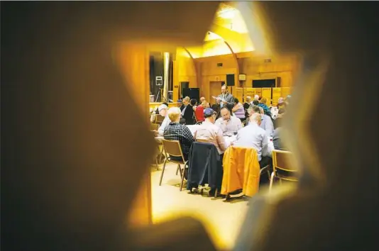  ?? Andrew Rush/Post-Gazette ?? Rabbi Howard Stein leads the final Passover seder on Tuesday at Temple Hadar Israel in New Castle. The synagogue will close its doors in December. More photos at post-gazette.com.