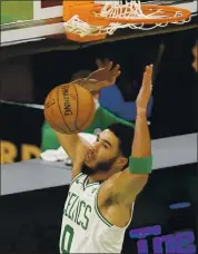  ?? ELISE AMENDOLA — THE ASSOCIATED PRESS ?? Celtics forward Jayson Tatum dunks for two of his teamhigh 32 points in Friday night’s victory over the Wizards