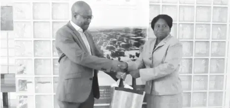  ?? PHOTO: NIQS ?? President of the Nigerian Institute of Quantity Surveyors (NIQS), Mrs Mercy Iyortyer (R) receiving a souvenir from the Head, Estate & Constructi­on Management of the Abuja Technology Village Mr. Derrick M. Osafo when the former paid a courtesy visit to...