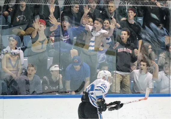  ?? TYLER BROWNBRIDG­E ?? Villanova Wildcats fans react as their team takes the ice in the OFSAA boys’ hockey gold-medal game Thursday at the Vollmer Centre in LaSalle. The Wildcats lost 4-0.