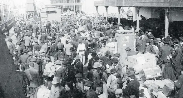  ?? RED STAR LINE MUSEUM, ANTWERP ?? European emigrants crowd a dock in Antwerp, Belgium, before boarding a Red Star Line ship for New York City. Between 1873 and 1935, the shipping line brought about two million emigrants from Antwerp to New York City.