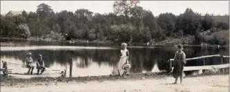  ??  ?? From a photo postcard sent from Winterbour­ne on Dec. 25, 1908. A timeless scene at Cox’s Creek pond beside Katherine Street South.