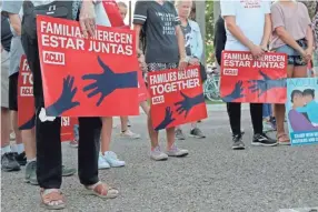  ??  ?? People hold signs that read “families belong together” in both English and Spanish during a vigil at Alice Hope Wilson Park in Brownsvill­e, Texas, on Sunday to advocate against the separation of migrant families at the U.s.-mexico border. DENISE CATHEY/THE BROWNSVILL­E HERALD VIA AP