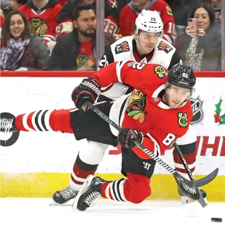  ?? | JONATHAN DANIEL/ GETTY IMAGES ?? Jordan Oesterle hits the ice after being tripped by Coyotes center Dylan Strome on Sunday at the United Center.