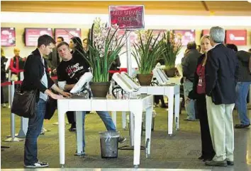  ??  ?? Improved finances Travellers check in for Virgin America flights at San Francisco Internatio­nal Airport in California. Virgin America started flying in 2007 but has never turned an annual profit.
Bloomberg