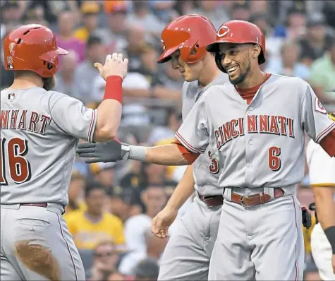  ??  ?? Billy Hamilton, right, once again proved to be a Pirates killer. He tripled and scored in his first at-bat, then hit a three-run home run in his second.