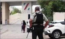  ?? KARIM TORRES / AP ?? Government forces guard the entrance of hotel after an armed confrontat­ion near Puerto Morelos, Mexico, Thursday. Two suspected drug dealers were killed after gunmen from competing gangs staged a dramatic shootout near upscale hotels.