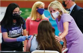  ?? (Carolyn Kaster/Reuters) ?? US FIRST LADY Jill Biden comforts a person during a tour at a COVID-19 vaccinatio­n site at Isaac Middle School in Phoenix, last month.