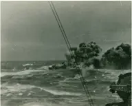  ?? ?? ■ Left: Shrouded in dense black smoke, HMS Glowworm wallows in the heavy swell having been repeatedly hit by fire from the Admiral Hipper. (Courtesy of Maurice Laarman)