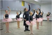  ?? AP PHOTO/EFREM LUKATSKY ?? A coach teaches girls Monday in a ballet studio in a bomb shelter in Kharkiv, Ukraine.