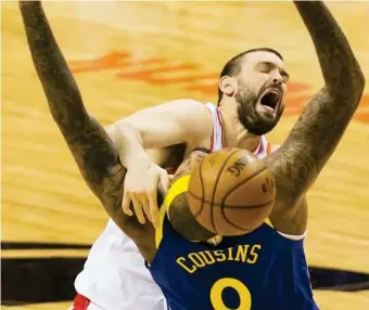  ??  ?? TORONTO RAPTORS center Marc Gasol, top, loses control of the ball under pressure from Golden State Warriors centrer DeMarcus Cousins (0) during first-half basketball action in Game 5 of the NBA Finals in Toronto, Monday, June 10, 2019. (AP)