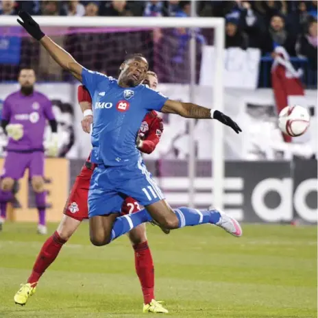  ?? RYAN REMIORZ/THE CANADIAN PRESS ?? Montreal’s Didier Drogba uses a bit of flair to keep the ball away from Toronto’s Josh Williams during action Thursday. Drogba scored once in a 3-0 win.