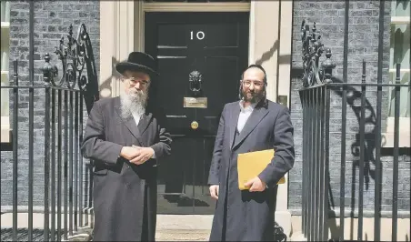  ?? (Courtesy Photo/Chaya Spitz ) ?? Pinter (left) stands beside Joel Friedman, the director of Public Affairs for the Interlink Foundation, an umbrella organizati­on for Orthodox Jewish charities on July 4, 2019, in Downing Street, London.