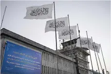  ?? Associated Press ?? ■ Taliban flags flutter at the airport in Kabul, Afghanista­n, Sept. 9, 2021. Afghan women unaccompan­ied by a male guardian have been allowed to board aircraft in the capital of Kabul since Saturday, airport officials said Tuesday, despite a Taliban order banning them from flying. There has been no official reversal of the order by the hard-liners in the Taliban leadership, who have been crafting increasing­ly repressive edicts.