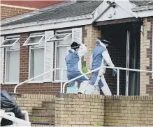  ??  ?? Forensic officers at the building.