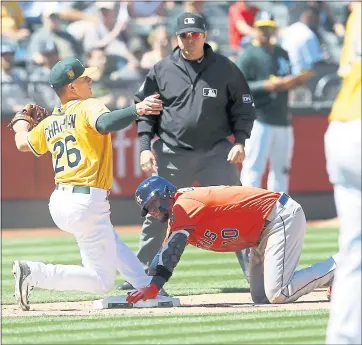  ?? JANE TYSKA — STAFF PHOTOGRAPH­ER ?? The Astros’ Yuli Gurriel is out at third base on a steal attempt as A’s third baseman Matt Chapman takes the throw.