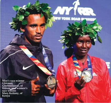  ??  ?? Men’s race winner Ghirmay Ghebreslas­sie, of Eritrea, and women’s race winner Mary Keitany, of Kenya