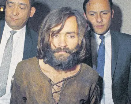  ??  ?? > Charles Manson is escorted to court on conspiracy-murder charges in 1969