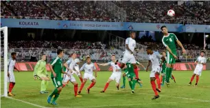  ?? AP ?? England’s Steven Sessegnon (in white) and Iraq’s Maytham Jabbar jump for the ball during the U-17 World Cup match in Kolkata. —