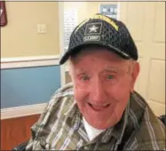  ?? PAUL POST -- PPOST@DIGITALFIR­STMEDIA.COM ?? World War II veteran Bob Velett proudly displays a new U.S. Army cap, one of many presents friends gave him for his 100th birthday.