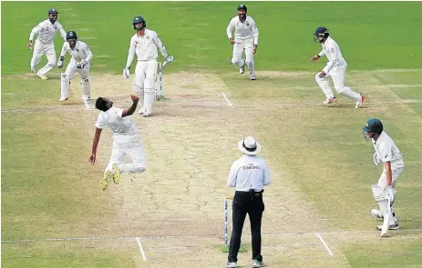  ?? /Reuters ?? Over the moon: India’s Ravichandr­an Ashwin, third left, celebrates with teammates after taking the wicket of Australia’s Peter Handscomb to win the second Test in Bengaluru on Tuesday. The victory enabled the hosts to level the four-match series at 1-1.