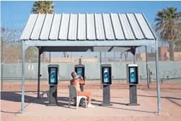  ?? THOMAS HAWTHORNE/THE REPUBLIC ?? An inmate on death row uses one of several pay phones at the Arizona State Prison Complex-Eyman in Florence. Until recently, death-row inmates at the prison spent very little time out of their cells.