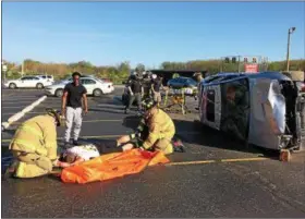  ?? CHAD FELTON — THE NEWS-HERALD ?? Jordan Dunnigan watches Painesvill­e Township firefighte­rs attend to Brandon Horn during Riverside High School’s “Stay in Your Lane” mock crash event on April 26. The program expanded this year to include a series of speakers with the aim of educating...