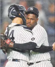  ?? Sarah Stier / Getty Images ?? Yankees pitcher Luis Severino, right, hugs catcher Gary Sanchez after recording the final out of Tuesday’s 7-1 win over the Rangers.