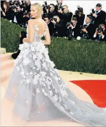  ?? Larry Busacca Getty Images ?? KAROLINA KURKOVA’S Marchesa dress was designed to light up and change color based on reactions on social media.