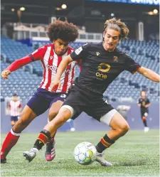  ?? CPL PHOTO ?? Sean Rea of Valour FC, right, keeps the ball away from Keesean Ferdinand of Atlético Ottawa during their match Thursday in Winnipeg.