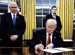  ?? JIM WATSON/GETTY-AFP ?? President Donald Trump signs an executive order on the Affordable Care Act on Friday.