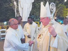  ?? ?? Archbishop Charles Balvo greeting Fr Sibichan Kaippanpla­ckal.