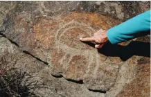  ??  ?? Iranian archeologi­st Mohammed Naserifard displays ancient engravings in the hills outside the town of Khomein.