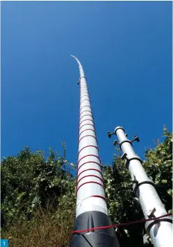  ??  ?? 1
Fig. 1: On the right you can see my retracted 12m aluminium mast (r) next to my 15m fibre mast (l). Both masts can be used independen­tly when the other is down. The lower 2m of the aluminium mast supports the fibre mast using two (35 x 35cm) Tufnol panels and 8 U-bolts. The 15m fibre glass mast is shown here with 20m of wire wound around it forming a helix antenna for 80m (see text).