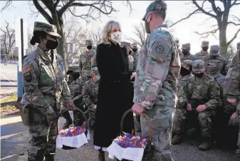  ?? Jacquelyn Martin / AFP via Getty Images ?? First lady Jill Biden brings chocolate chip cookies to National Guard members outside the U.S. Capitol as a gesture of thanks for their service during inaugurati­on ceremonies in Washington.