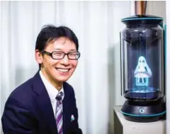  ?? BEHROUZ MEHRI/AFP ?? Akihiko Kondo poses next to a hologram of Japanese virtual reality singer Hatsune Miku at his apartment in Tokyo.