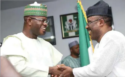  ??  ?? Bello in a warm handshake with Adeyemi