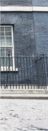  ??  ?? Palmerston, the Foreign & Commonweal­th Office cat, stalks past 10 Downing Street in front of the waiting media yesterday. Larry, his rival at No 10, was nowhere to be seen