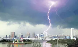  ?? AP ?? Lightning illuminate­s the sky over the Olympic rings and the Rainbow Bridge in Tokyo, Japan on Sunday, July 11.