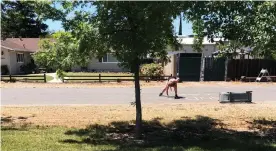  ?? Courtesy of Rouble Claire ?? A woman appears to be writing the words “sand n **** r,” a racist slur used against people of Middle Eastern descent, in chalk outside of Rouble Claire’s house on May 11, 2021, in Sutter County.