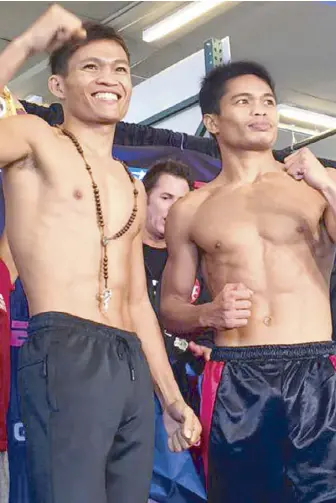  ??  ?? IBF superflywe­ight champion Jerwin Ancajas (left) and challenger Jonas Sultan at Friday’s weigh-in.