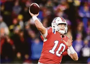  ?? Billie Weiss / Getty Images ?? The Patriots’ Mac Jones throws during a game against the Bills at Gillette Stadium on Dec. 1 in Foxborough, Mass.