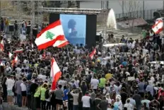  ?? Hussein Malla/Associated Press ?? People watch last week’s massive explosion on a giant screen Tuesday in Beirut as they gather in honor of the victims of the catastroph­e, which killed many and devastated the city.